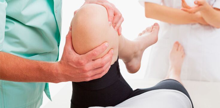 doctor examining knee for pain